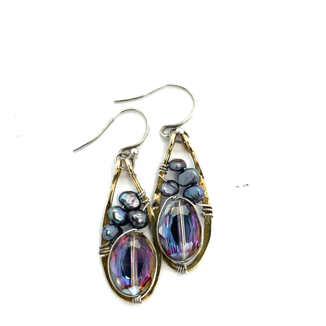 Pair of earrings with purple and blue stones on a white background