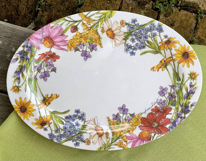Oval-shaped plate with floral design on a green surface