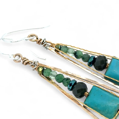 Earrings with green and blue beads and turquoise stones on a white background