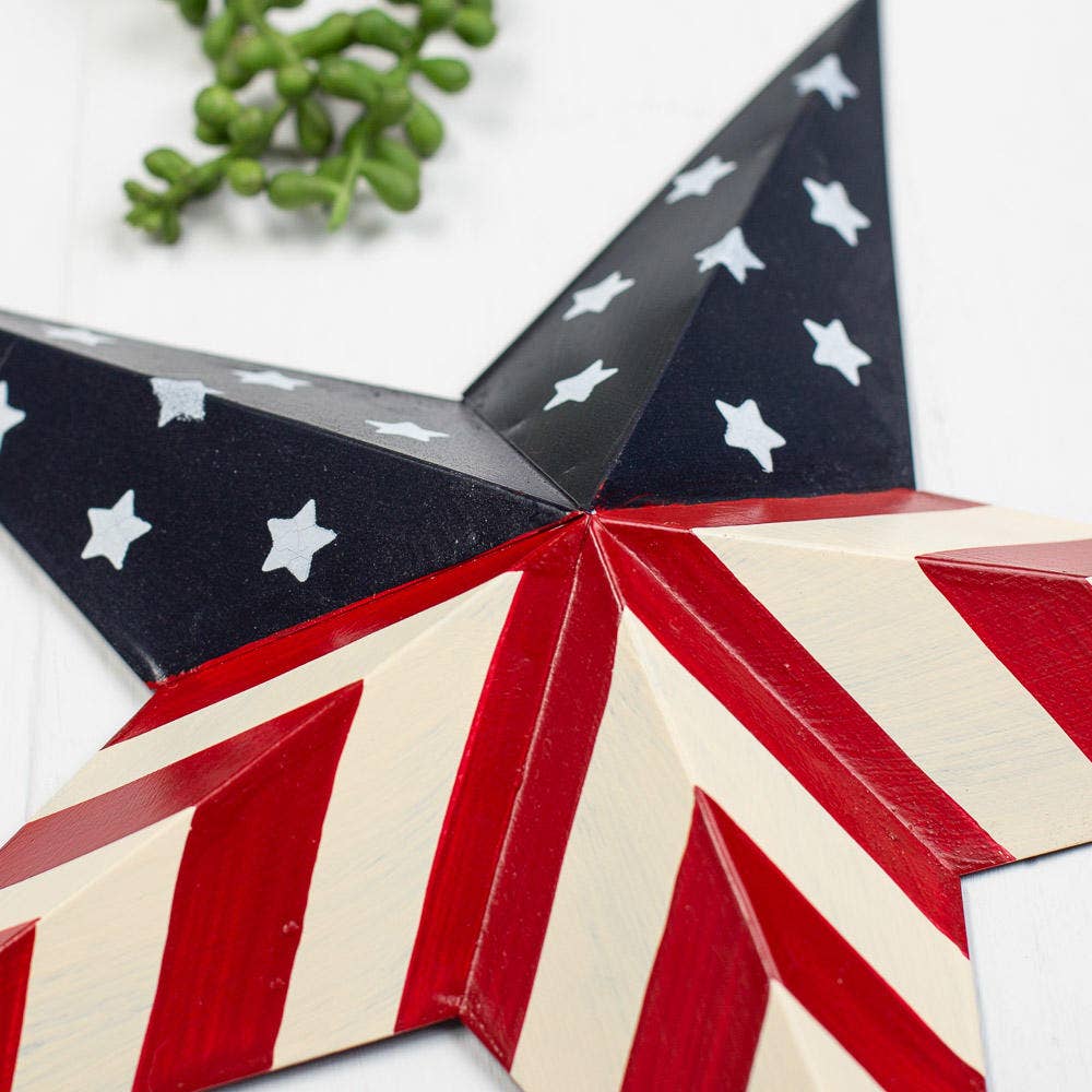 Decorative star with American flag pattern on a white background with greenery