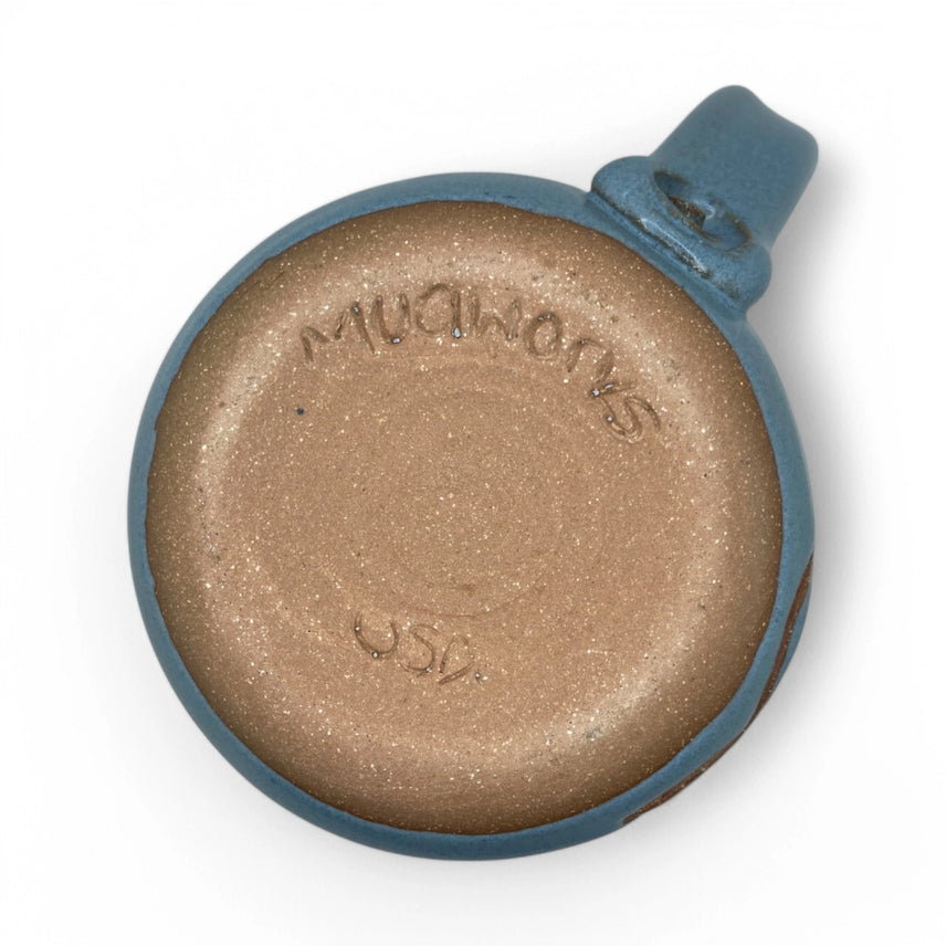 Bottom of ceramic mug with "Mudworks USA" branding on a white background