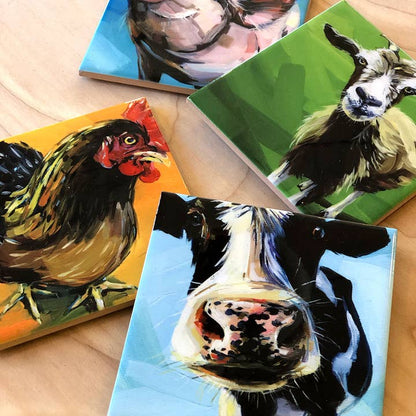 Four colorful coasters featuring animal portraits on a wooden surface.