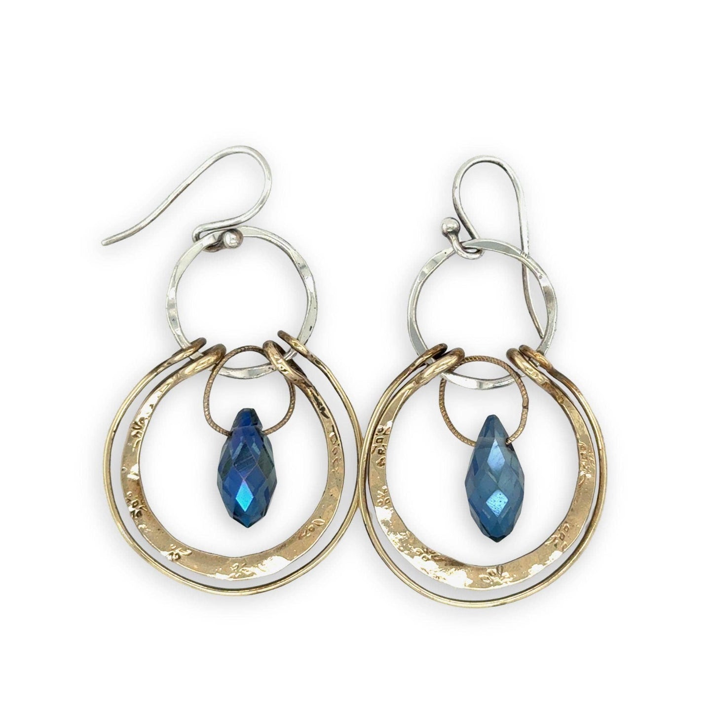 Pair of hoop earrings with blue gemstones on a white background