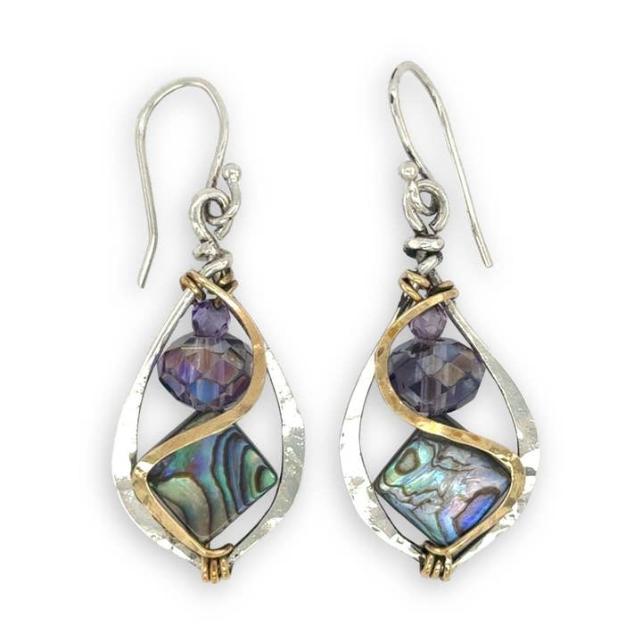 Pair of earrings with purple and green gemstones on a white background