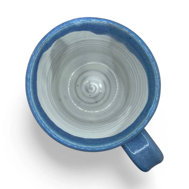 Blue and white ceramic mug on a white background
