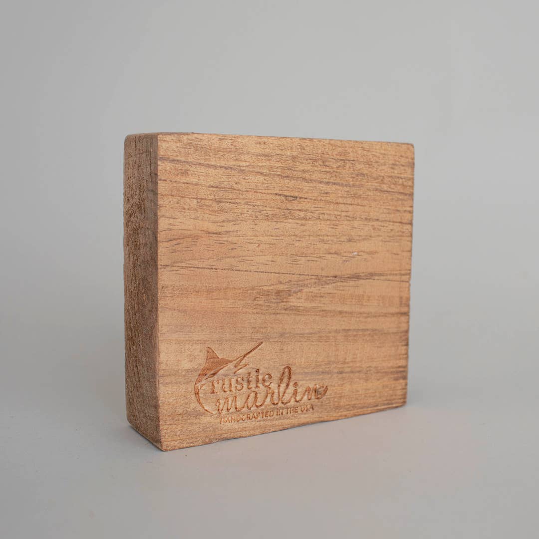 Wooden block with 'Rustic Marlin' branding on a gray background