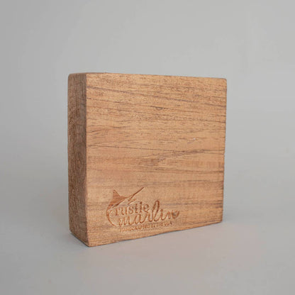 Wooden block with 'Rustic Marlin' branding on a gray background