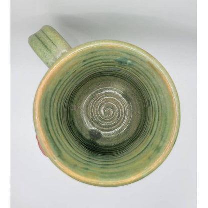 Green ceramic mug with a spiral design on a white background