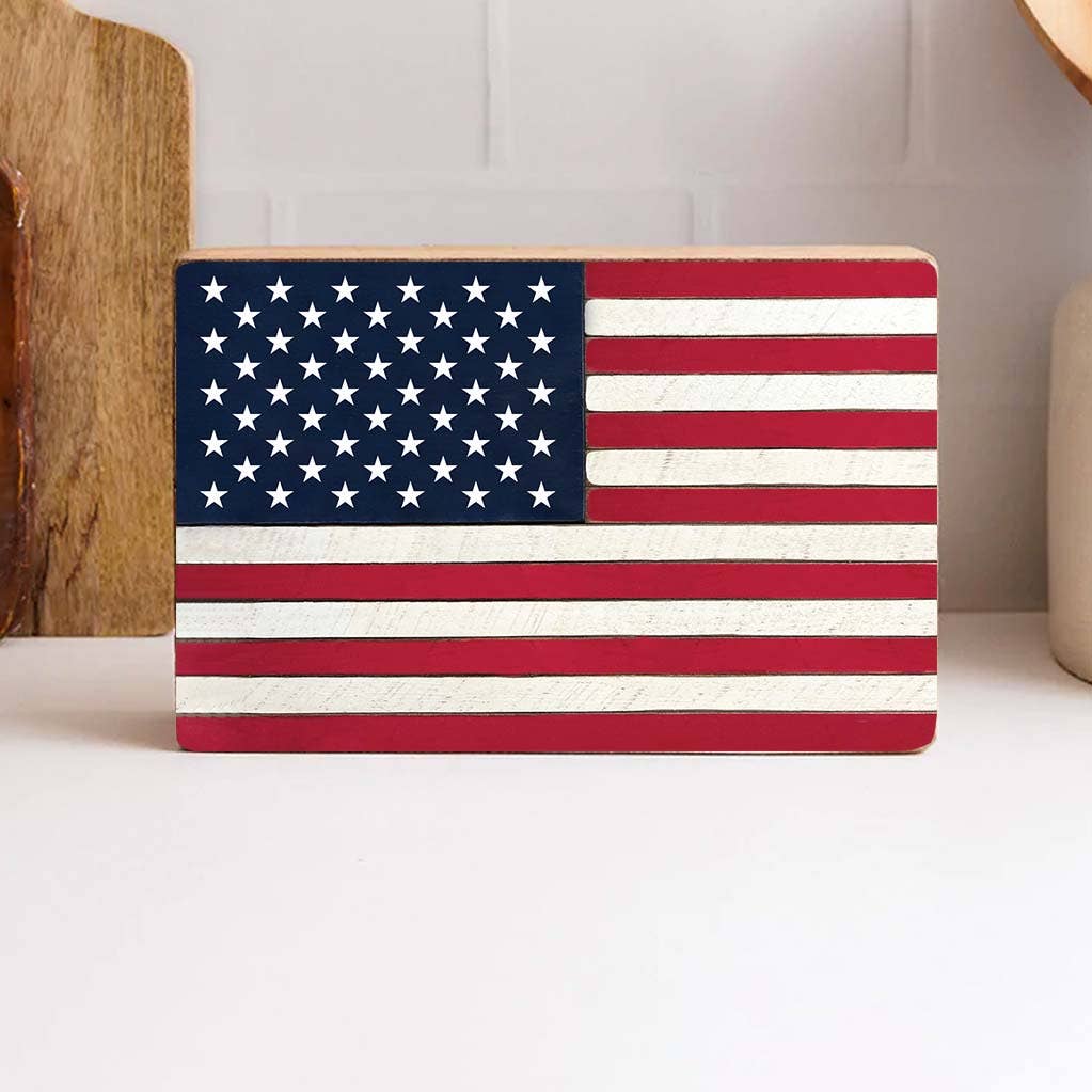 Wooden plaque with American flag design on a white surface