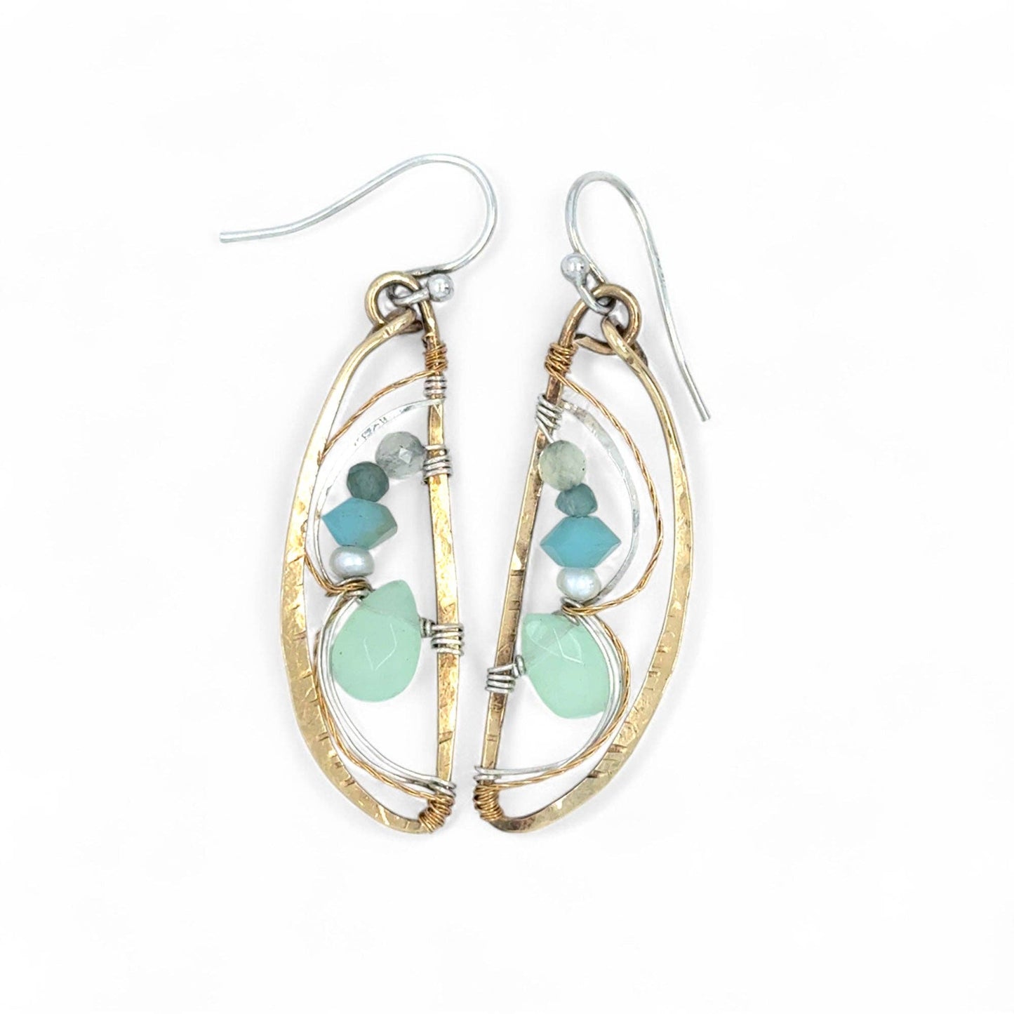 Gold and silver earrings with turquoise stones on a white background