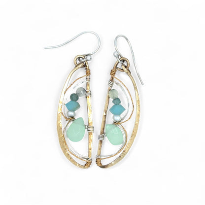 Gold and silver earrings with turquoise stones on a white background