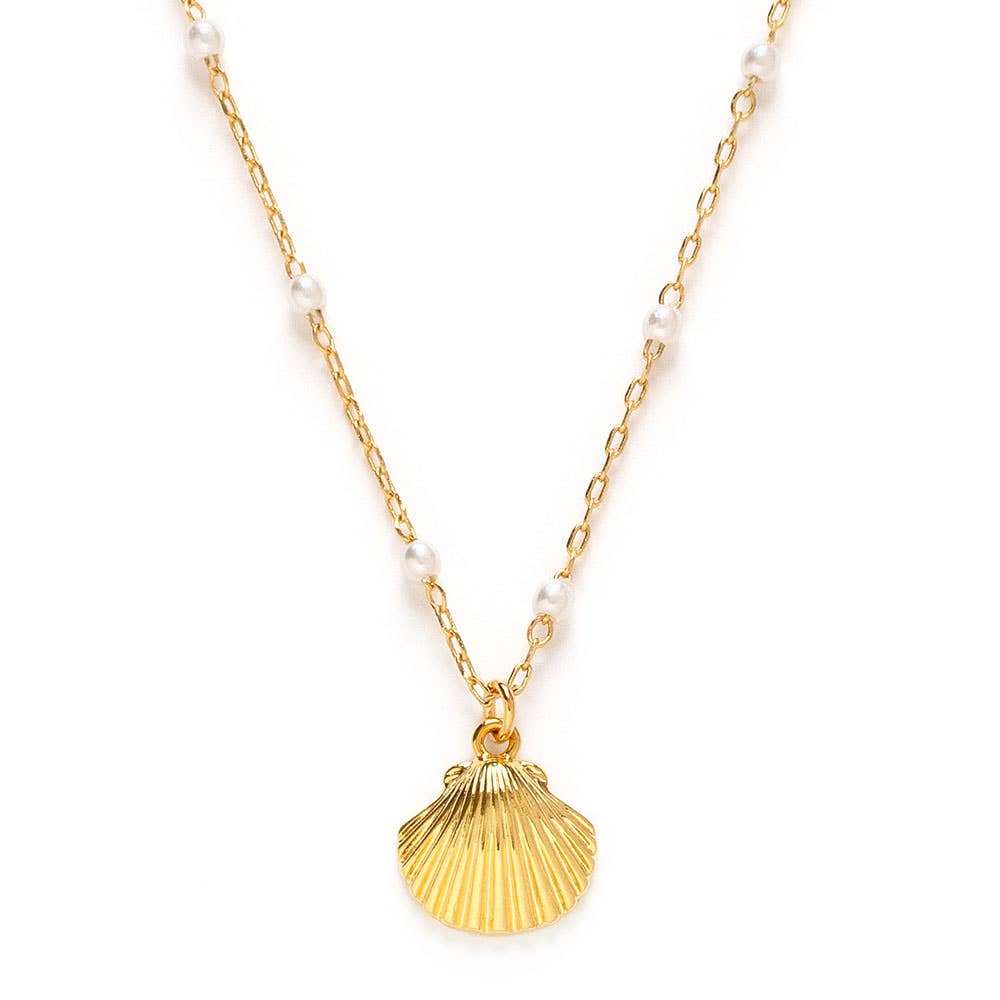 Gold shell pendant necklace with white pearls on a gold chain against a white background