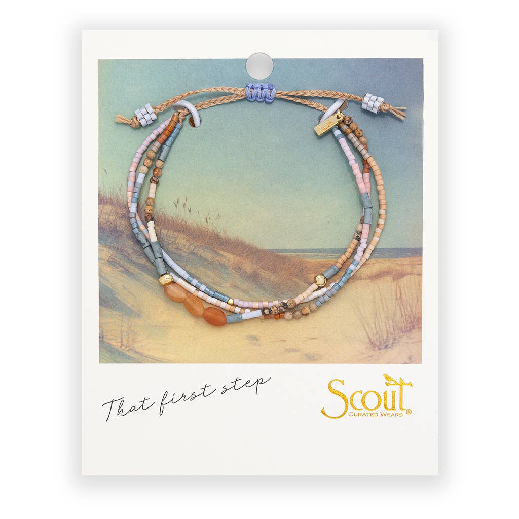 Beaded bracelets on a card with a scenic background and 'Scout' branding.