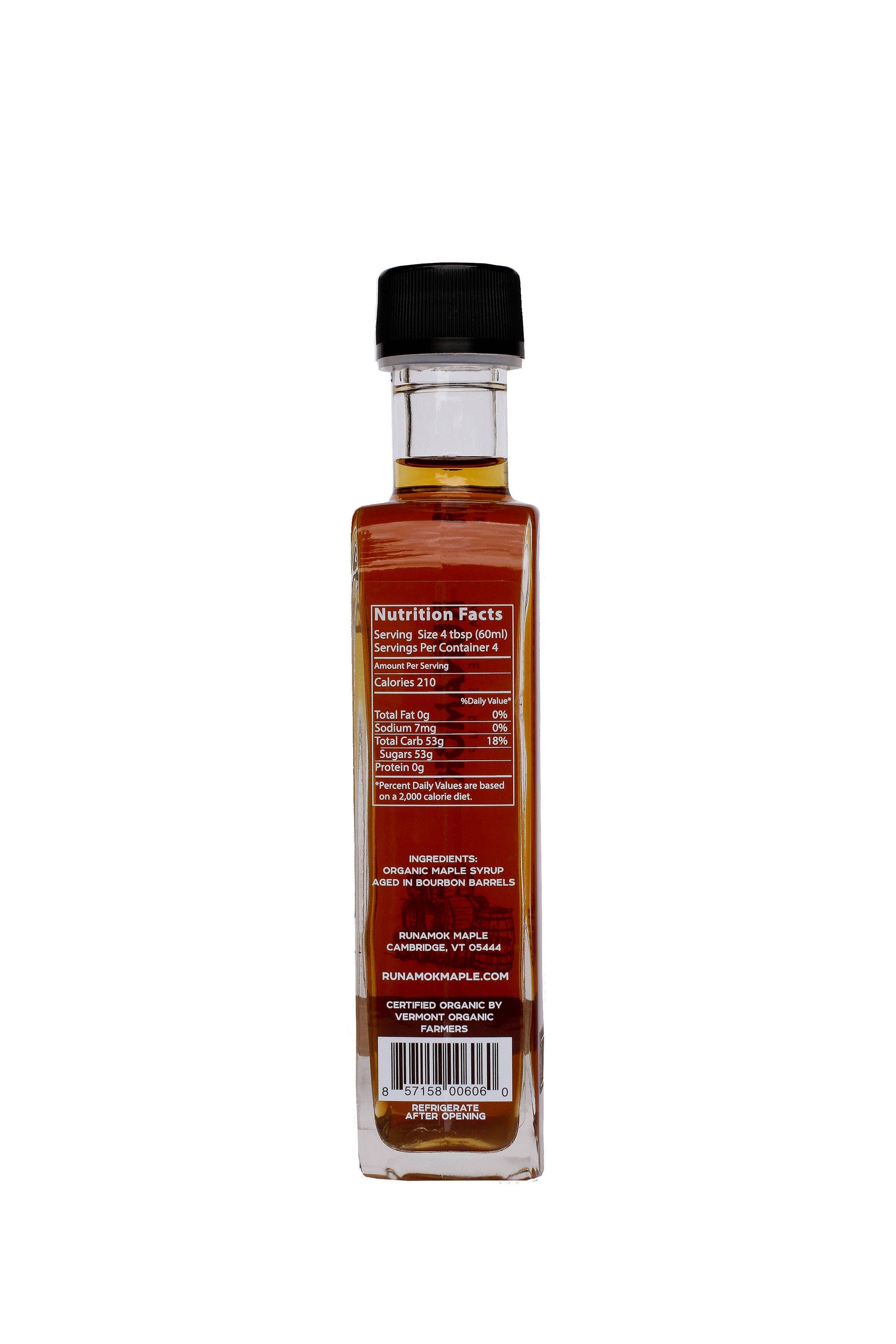 A clear glass bottle of maple syrup with a black cap, showing the back label with nutrition facts and a barcode, on a white background.