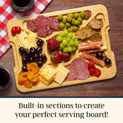 Wooden charcuterie board with various foods including meats, cheeses, fruits, and nuts on a wooden surface. Text at the bottom: Built-in sections to create your perfect serving board!