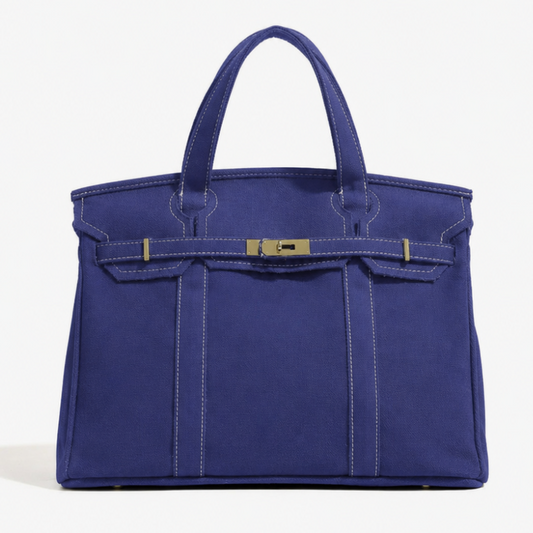 Blue handbag with gold accents on a white background