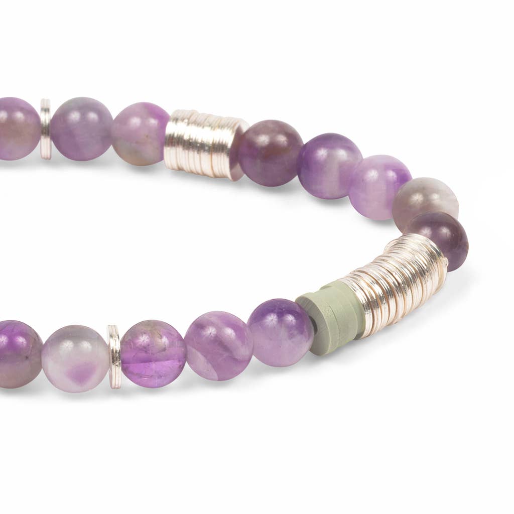 Purple beaded bracelet with silver and gold accents on a white background