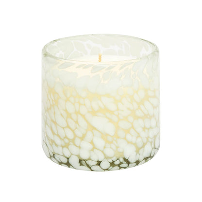 Candle in a glass container with a marble-like pattern on a white background