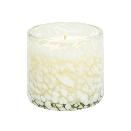 Candle in a glass container with a marble-like pattern on a white background