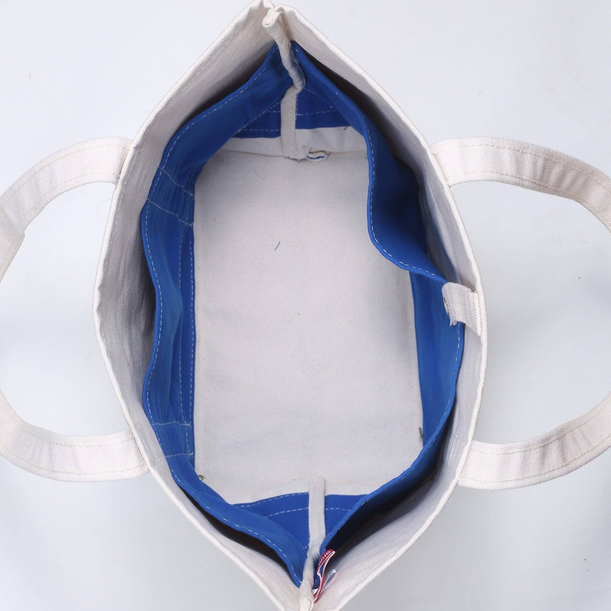 White tote bag with blue interior lining on a white background