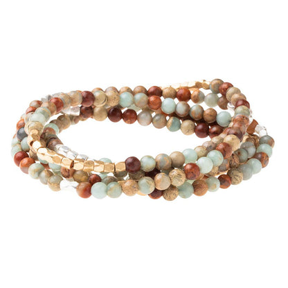 Convertible beaded necklace/wrap bracelet on a white background