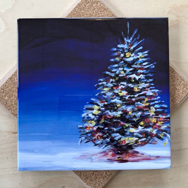 Trivet with a painting of a Christmas tree with lights on a dark blue background.