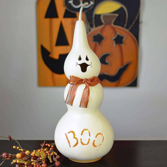 Decorative gourd with ghost face and 'BOO' text, Halloween-themed background