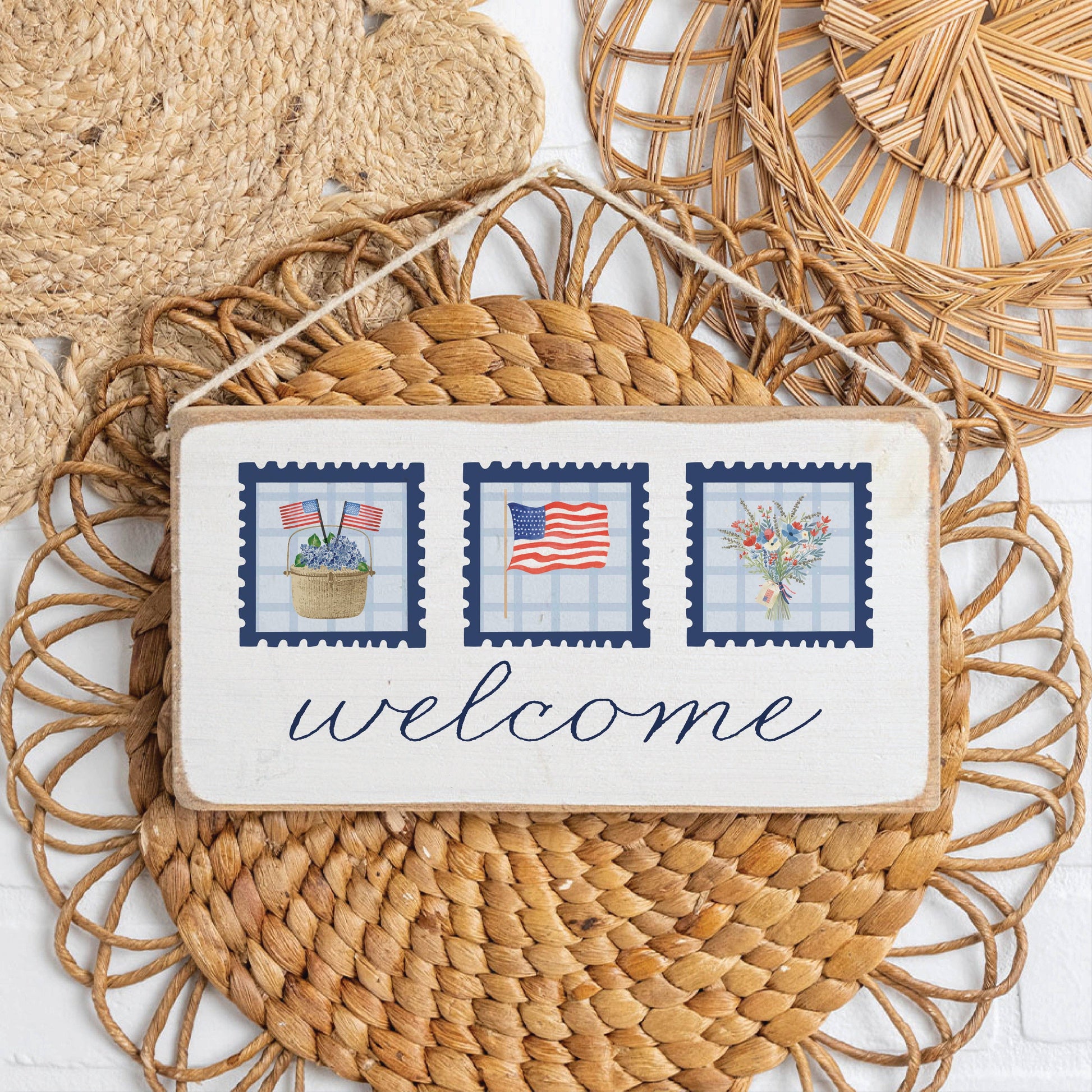 Decorative sign with 'welcome' text and patriotic design on a woven mat.