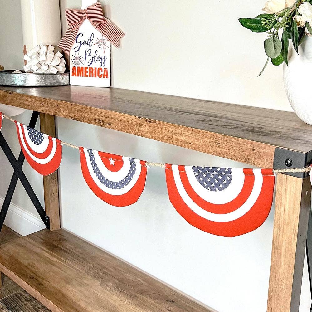 Patriotic banner with red, white, and blue design hanging on a wooden shelf.