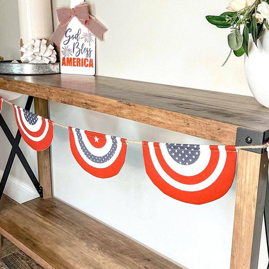Patriotic banner with red, white, and blue design hanging on a wooden shelf.