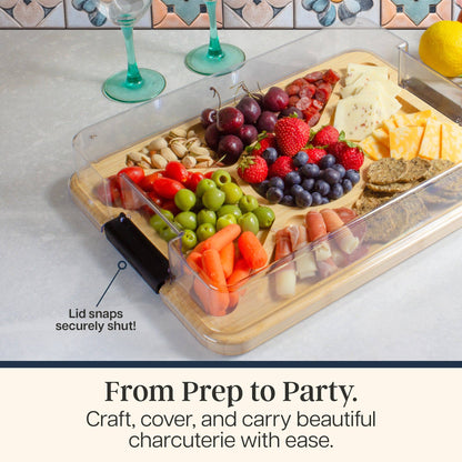 Charcuterie board with fruits, vegetables, and cheese on a countertop with text 'From Prep to Party': Craft, cover, and carry beautiful charcuterie with ease. Lid snaps securely shut!