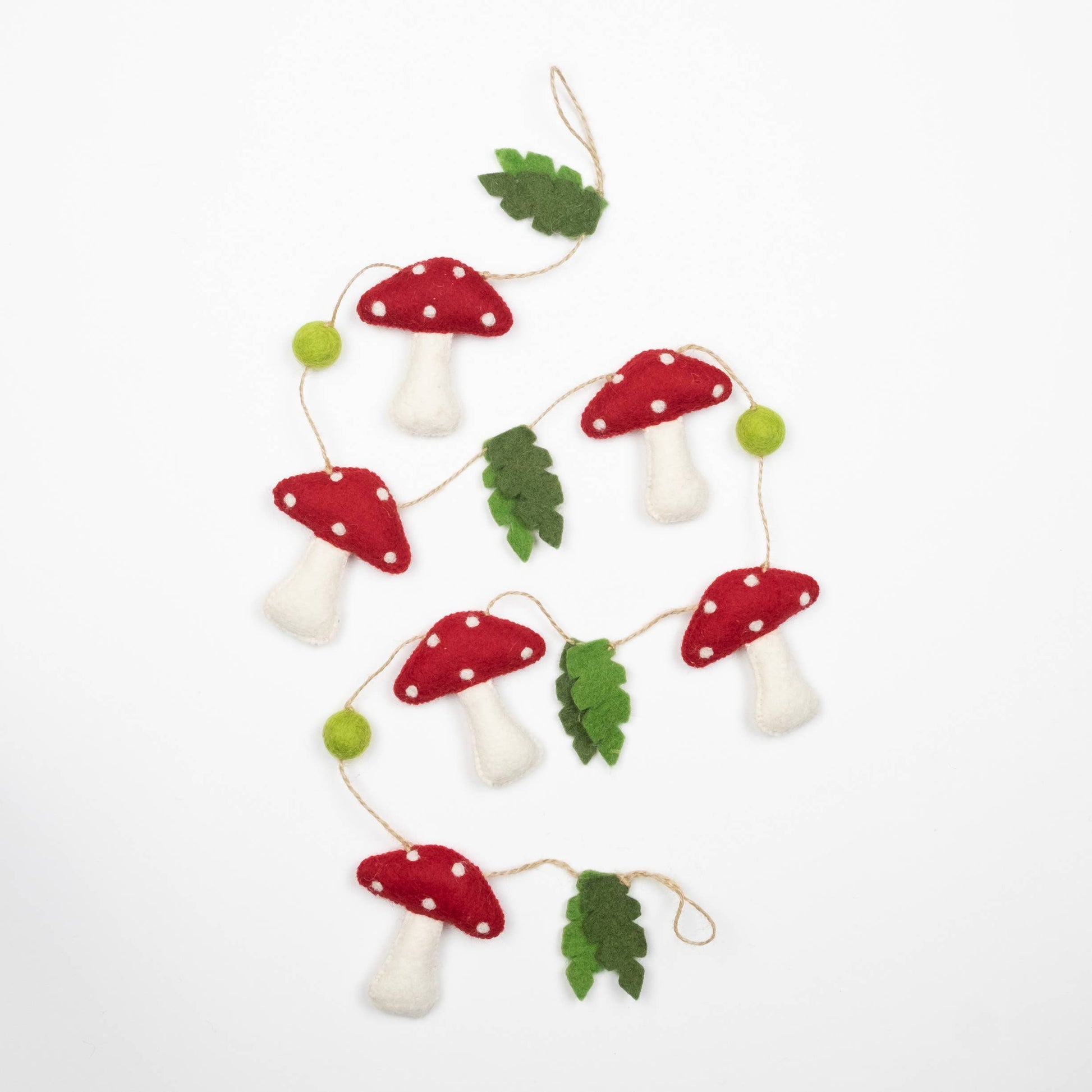 Felt mushroom garland with red caps and white spots on a white background