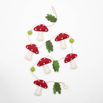 Felt mushroom garland with red caps and white spots on a white background