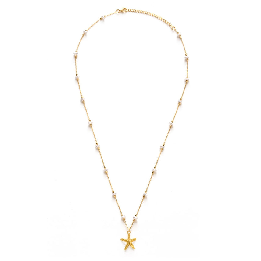Gold necklace with a starfish pendant on a white background