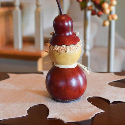 Decorative scarecrow gourd rear view on a table with a blurred background