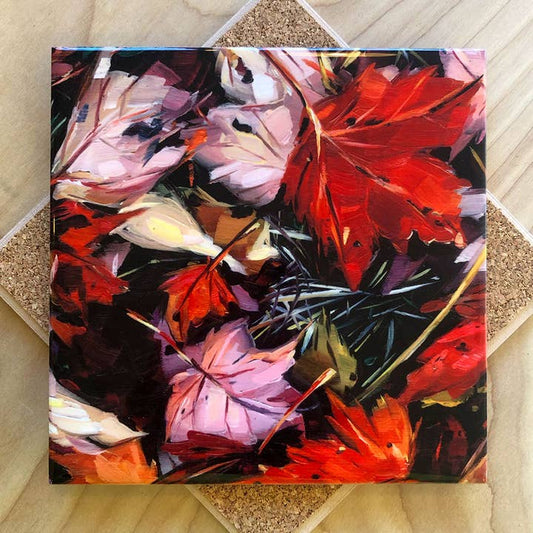 Trivet with a painting of leaves on a textured surface