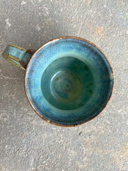 Blue ceramic mug on a gray surface