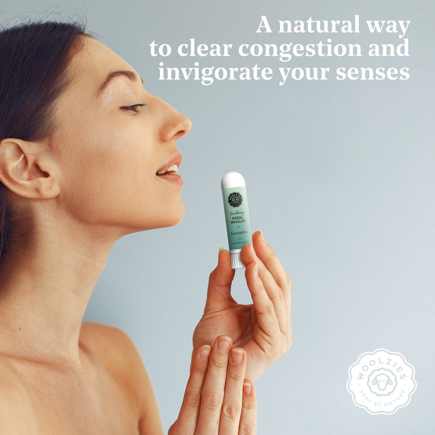 Woman holding a nasal inhaler with text about clearing congestion and invigorating senses on a light blue background.
