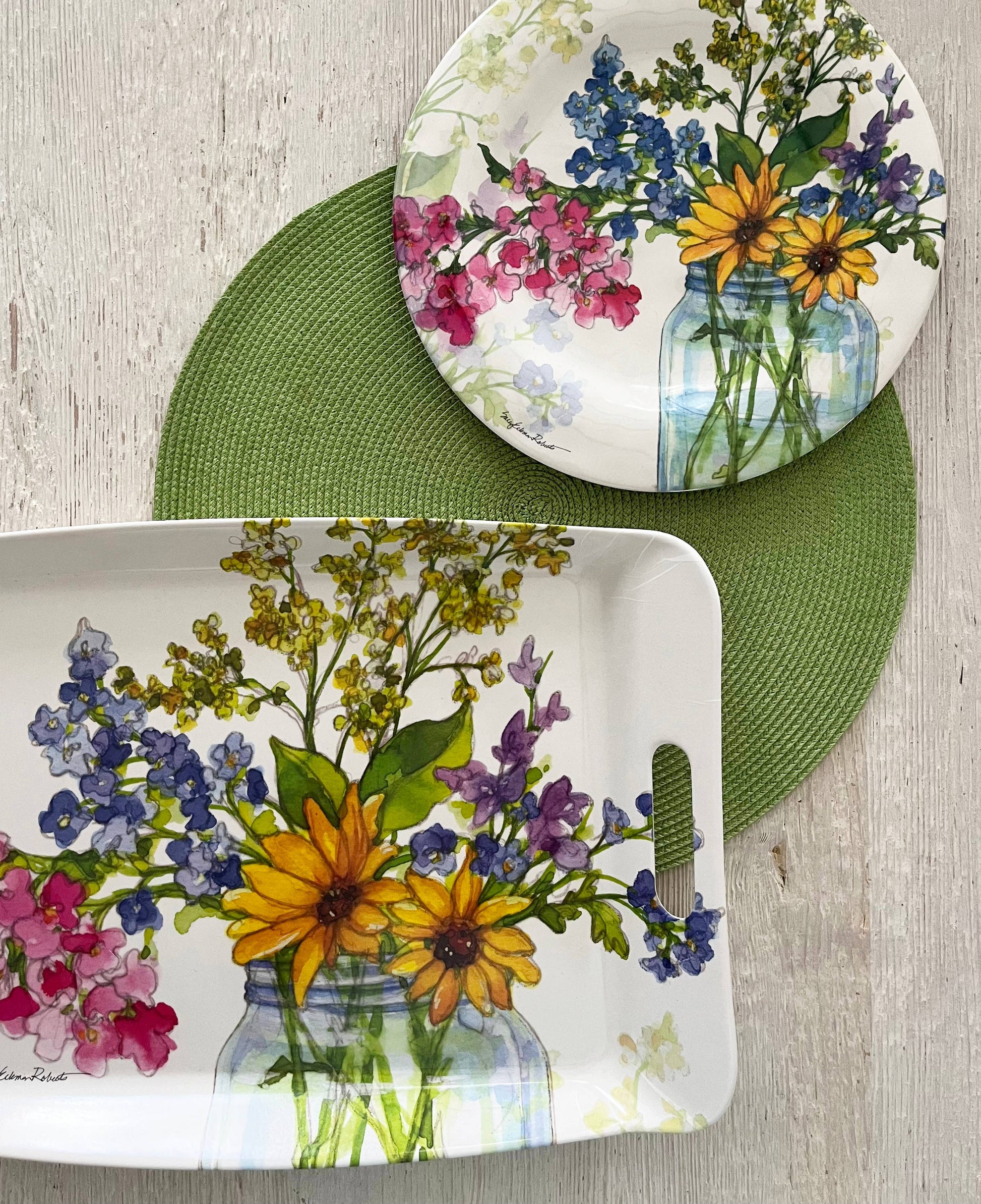 Dish set with floral design on a wooden surface