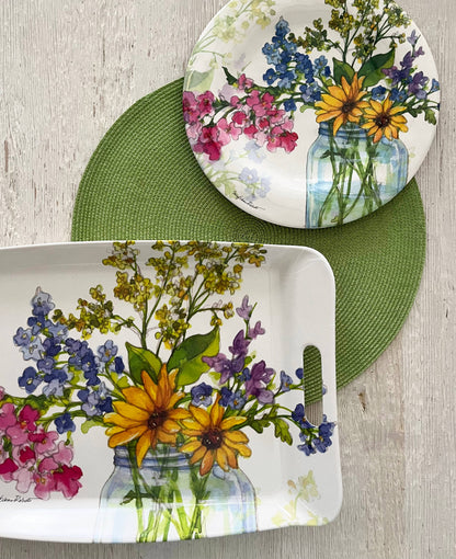 Dish set with floral design on a wooden surface