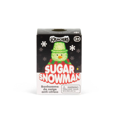 Scrunchems Sugar Snowman anti-stress sugar scrunchie in its original black and white packaging box, featuring a green snowman illustration.