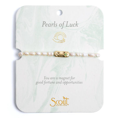 Pearls of Luck bracelet on a Scout branded card with text and logo.