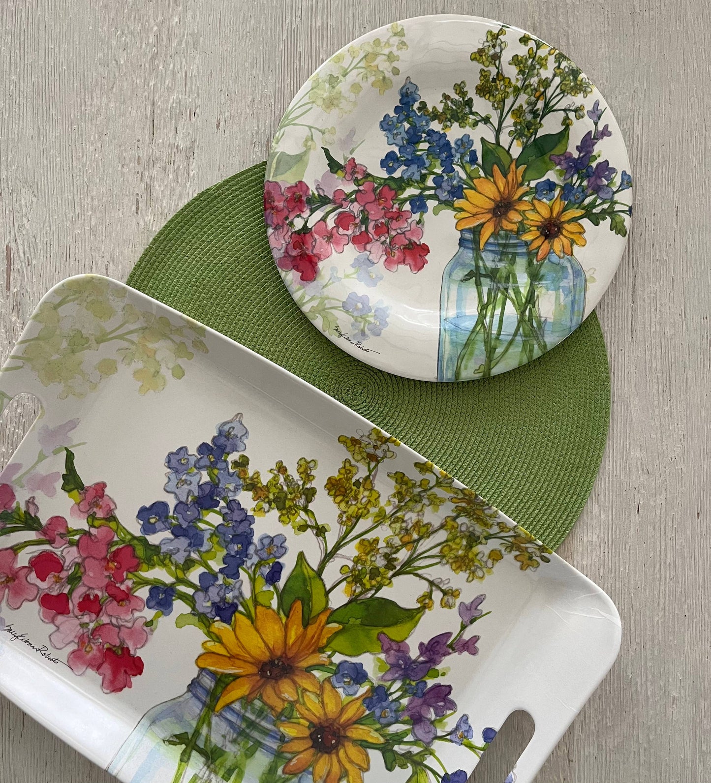 Dish set with floral design on a wooden surface