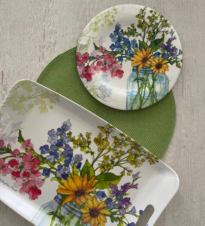 Dish set with floral design on a wooden surface