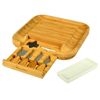 Wooden charcuterie board with cutlery holder and soap on a white background