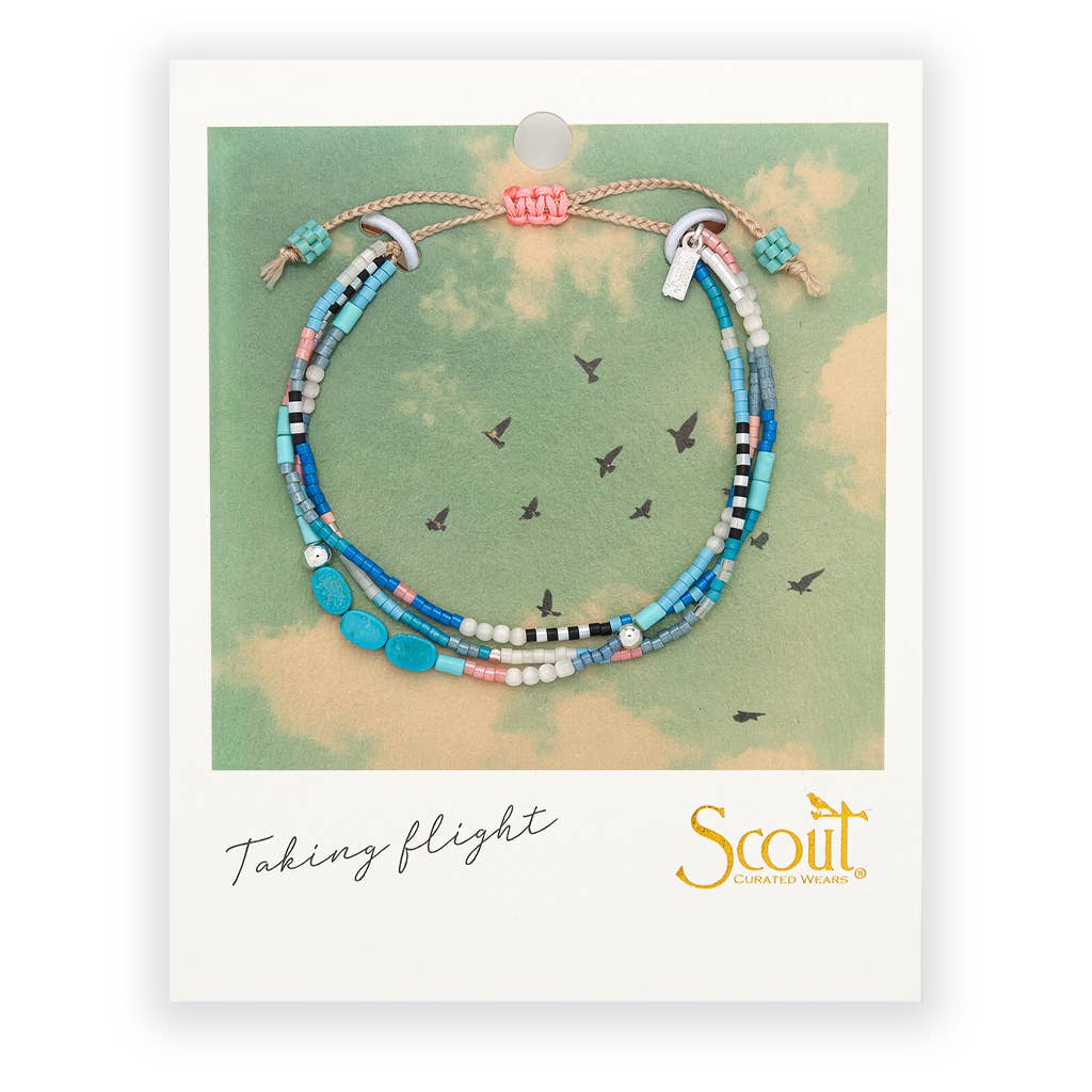 Beaded bracelet on a Scout branded card with a sky background