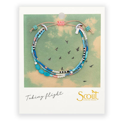 Beaded bracelet on a Scout branded card with a sky background