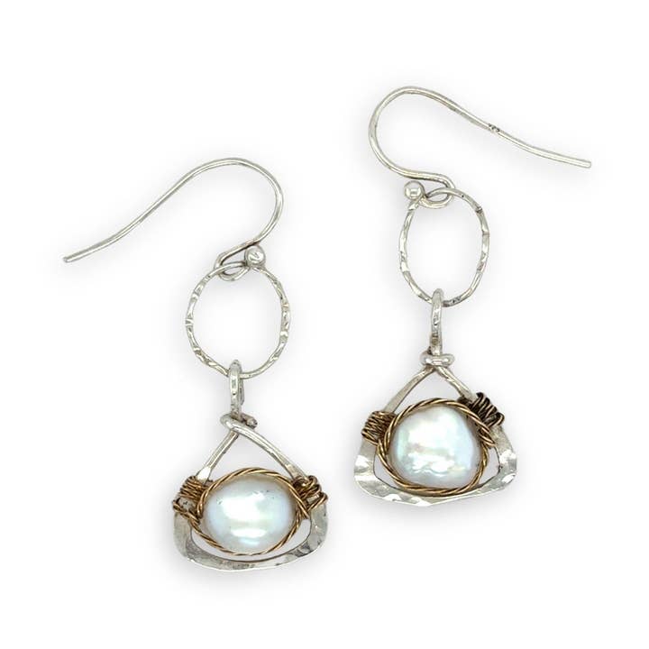 Pair of silver earrings with pearls on a white background