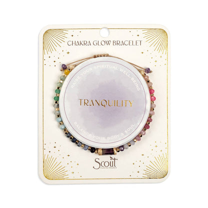 Chakra glow bracelet packaging with 'Tranquility' and 'Scout' branding on a white background. Gallery images show this same piece from multiple angles and in styled settings.