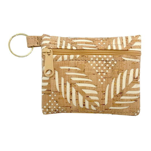 A small rectangular pouch made from natural cork with a cream-colored leaf and geometric pattern, featuring a gold-tone zipper and a matching gold-tone key ring.